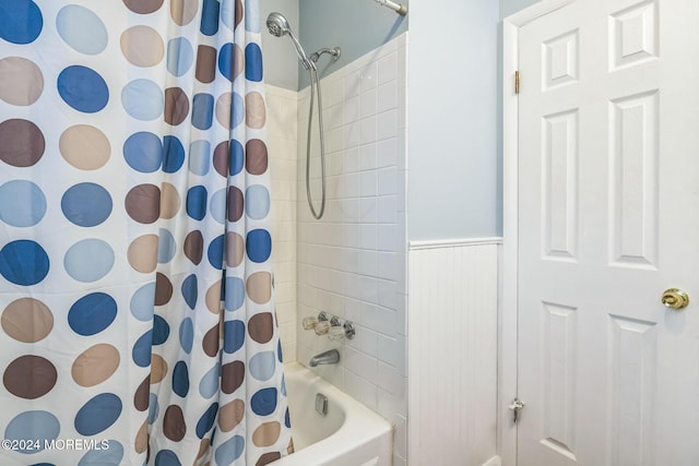 bathroom with shower / bath combo with shower curtain