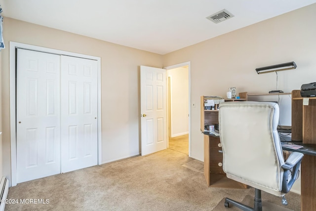 carpeted office with a baseboard radiator