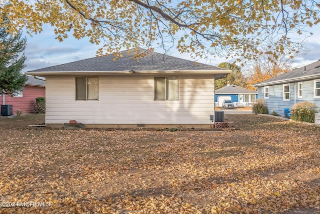 view of side of home featuring central AC