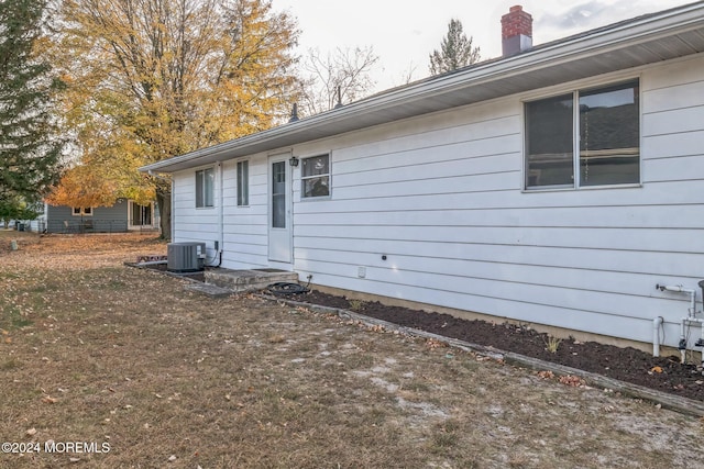 view of side of home with central AC unit