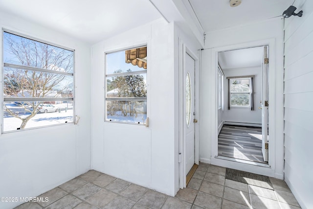 doorway featuring light tile patterned floors and a baseboard heating unit