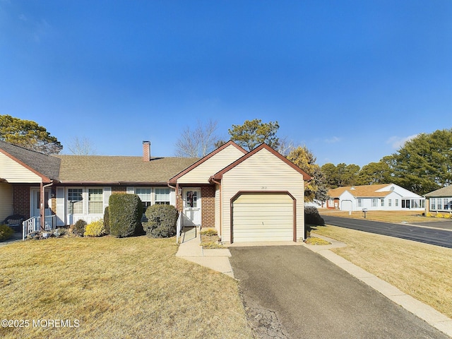 single story home with a front yard and a garage