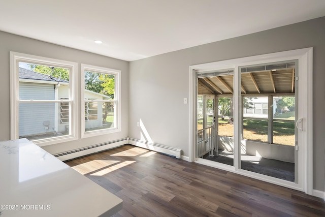 interior space featuring baseboard heating and dark hardwood / wood-style floors