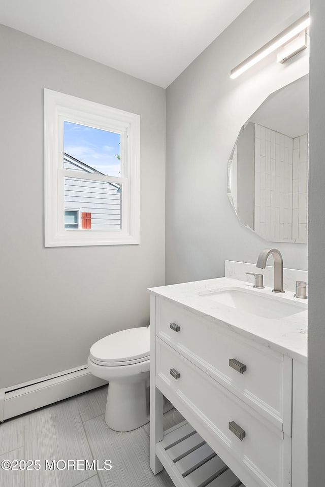 bathroom featuring toilet, vanity, tile patterned flooring, and a baseboard radiator