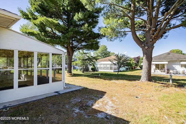 view of yard featuring a sunroom