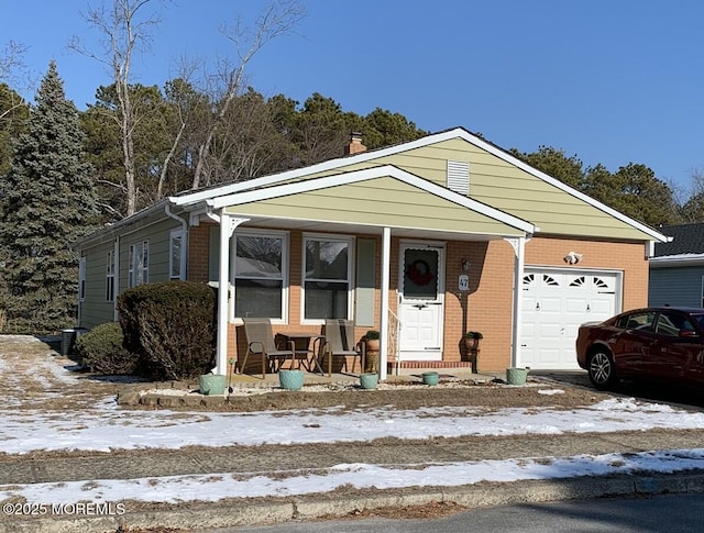 view of front of property with a porch and a garage