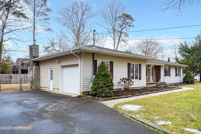 ranch-style home with a garage and a front yard