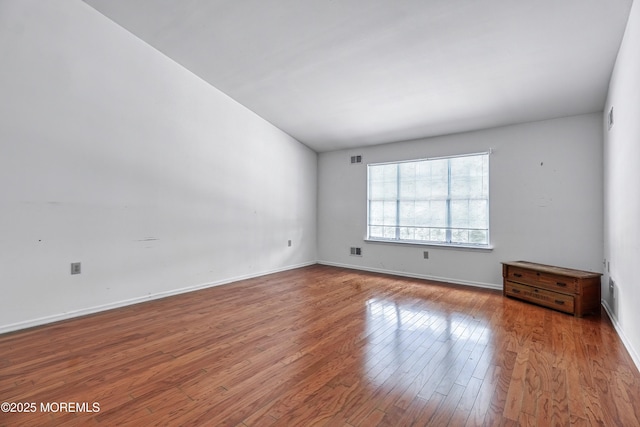 spare room featuring hardwood / wood-style floors