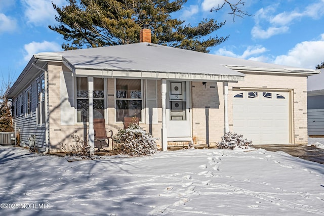 view of front of house featuring a porch, a garage, and central air condition unit