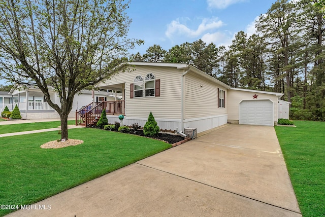 view of front facade featuring a garage, a front lawn, and covered porch