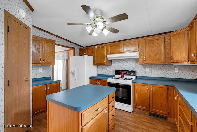 kitchen with white fridge with ice dispenser, light wood-type flooring, a center island, vaulted ceiling, and gas range