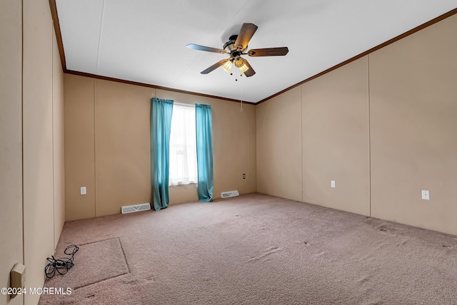 carpeted empty room featuring ceiling fan and crown molding