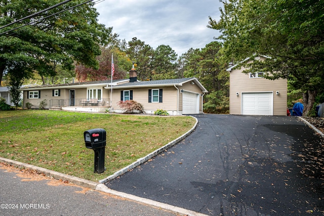 ranch-style home with a front lawn and a garage