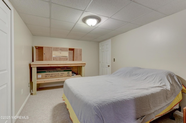 bedroom featuring carpet floors and a paneled ceiling