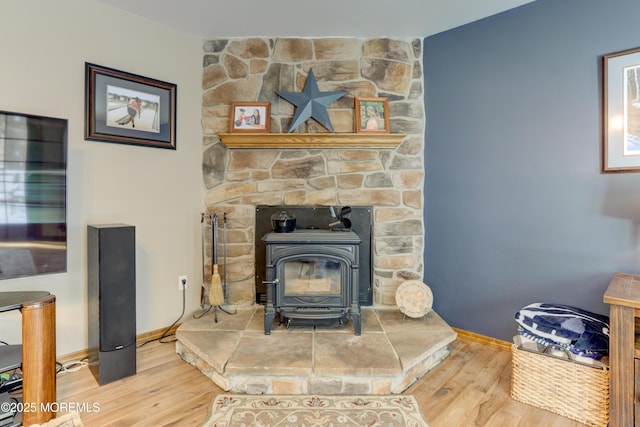 details featuring wood-type flooring and a wood stove