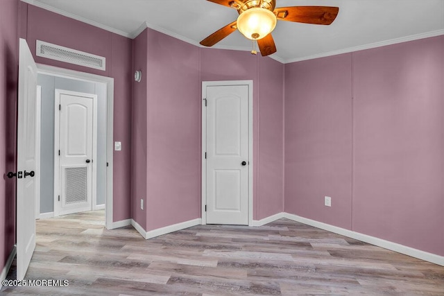 unfurnished bedroom featuring crown molding, light hardwood / wood-style flooring, and ceiling fan