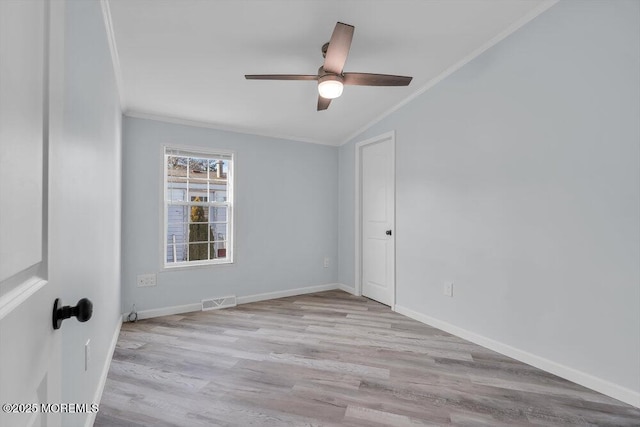 unfurnished room with crown molding, light hardwood / wood-style floors, and ceiling fan