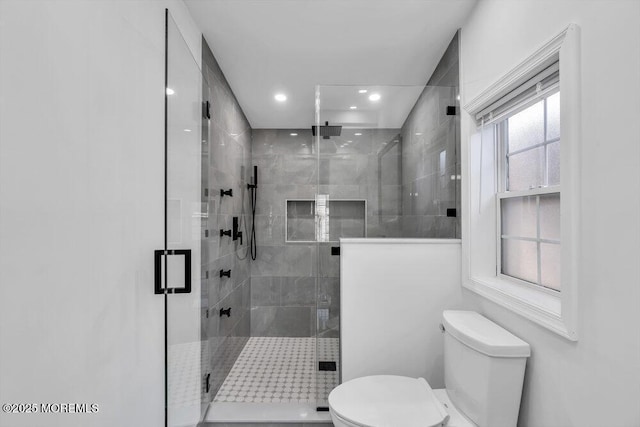 bathroom featuring toilet and walk in shower