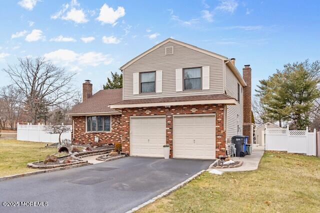 front facade featuring a front lawn and a garage