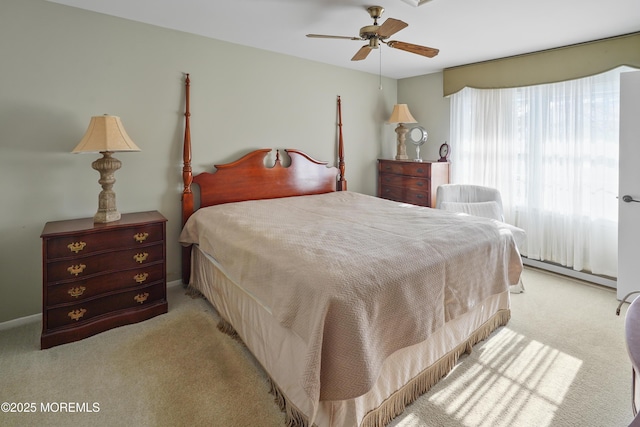 bedroom with ceiling fan and light carpet