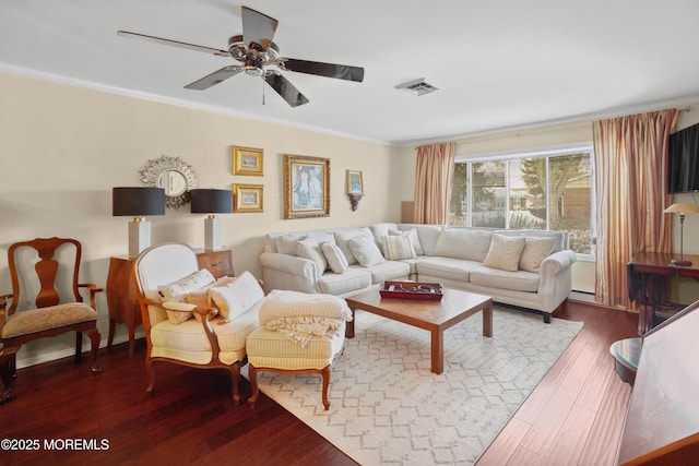 living room featuring hardwood / wood-style flooring, ornamental molding, and ceiling fan