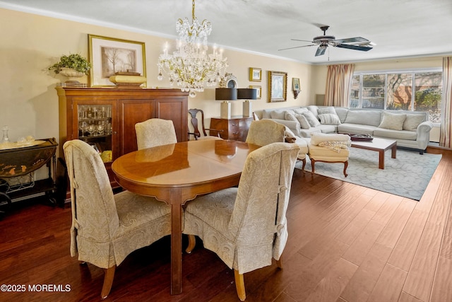 dining area with dark hardwood / wood-style flooring, ceiling fan with notable chandelier, and ornamental molding