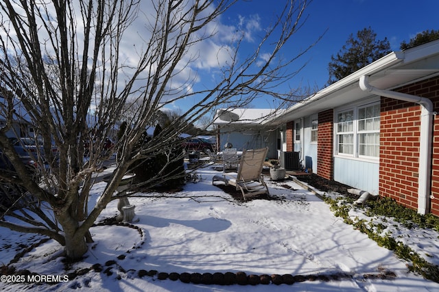 snowy yard with central AC unit