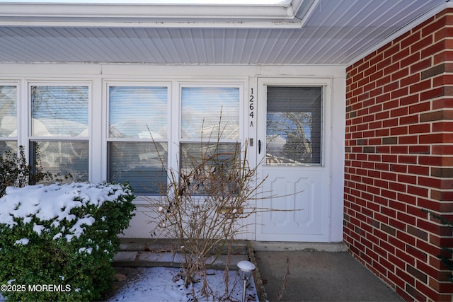 view of snow covered property entrance