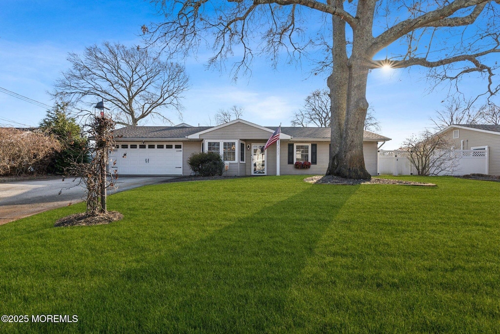 single story home featuring a front yard and a garage