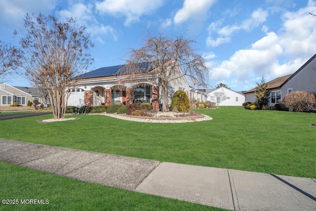 exterior space featuring a front yard and solar panels