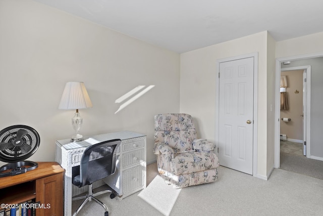 carpeted office with a baseboard heating unit