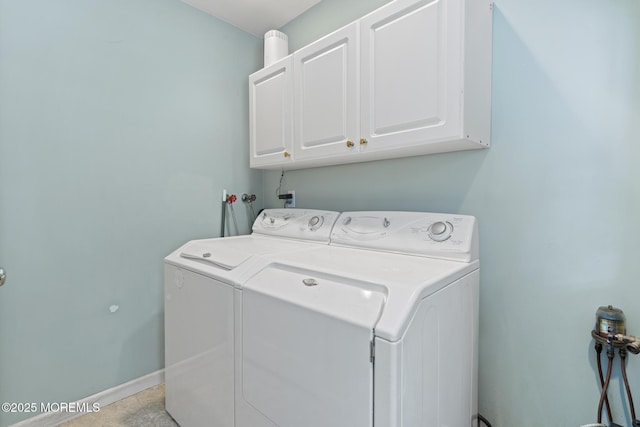 laundry room with cabinets and washing machine and dryer