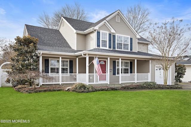 view of front of property with a garage, covered porch, and a front lawn