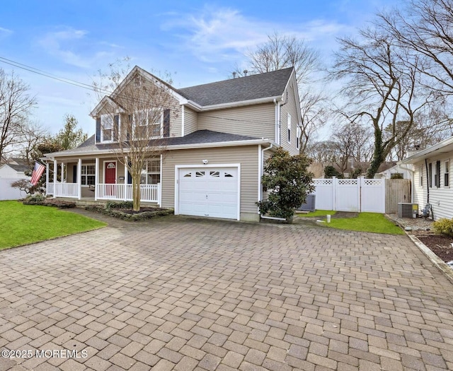 view of front facade featuring central AC unit, a garage, a front yard, and a porch