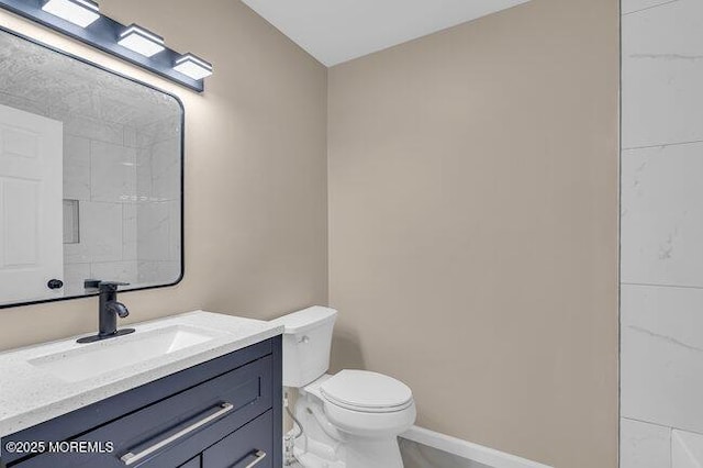 bathroom with toilet and vanity