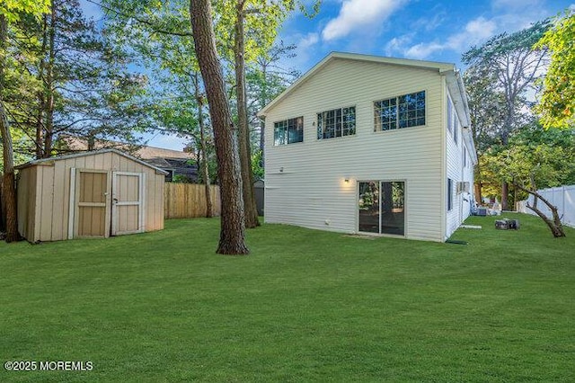 back of house with a storage unit and a yard