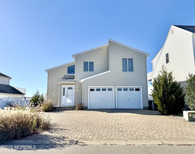 view of front of property featuring a garage and decorative driveway