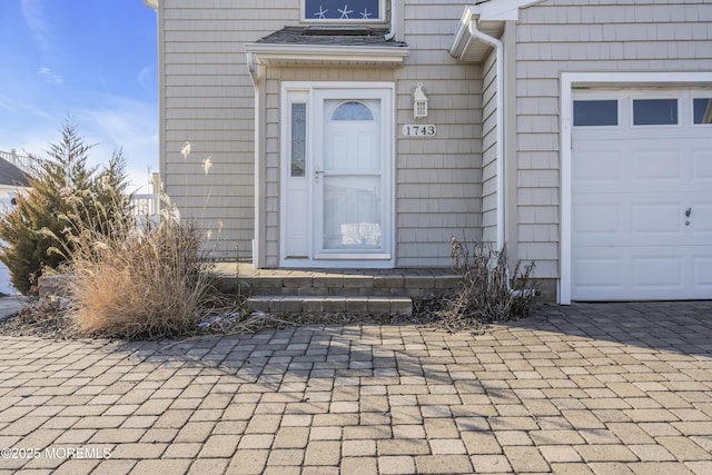 doorway to property featuring a garage