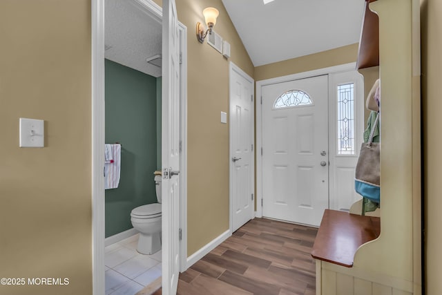 entrance foyer with hardwood / wood-style flooring and lofted ceiling