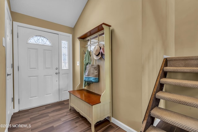 entrance foyer featuring lofted ceiling and dark hardwood / wood-style flooring