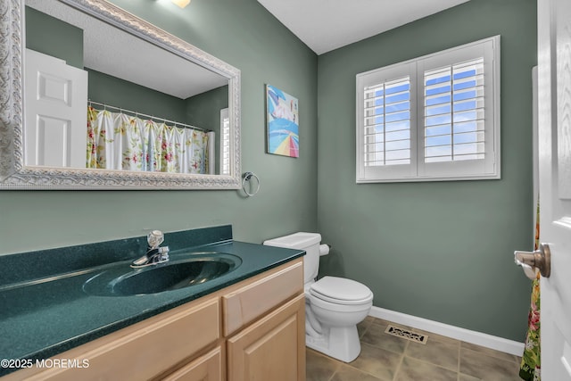 bathroom featuring tile patterned floors, vanity, and toilet