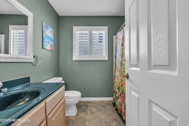 bathroom with vanity, tile patterned floors, and toilet