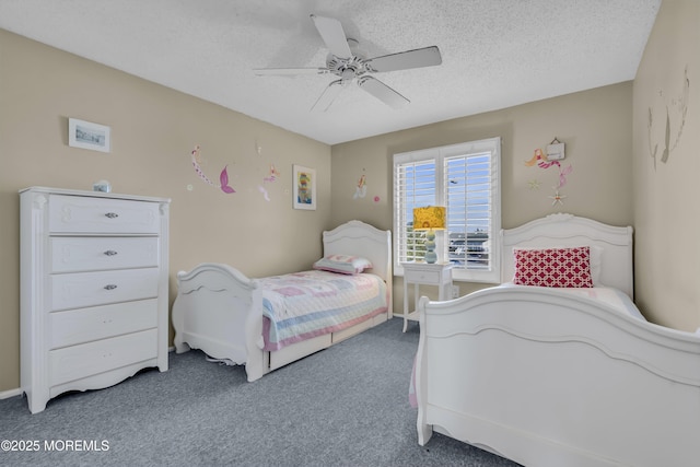 bedroom featuring ceiling fan, carpet floors, and a textured ceiling