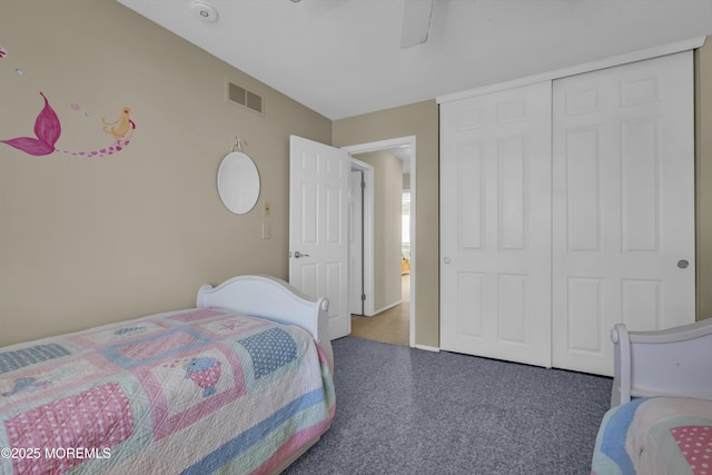 bedroom with dark carpet, a closet, and ceiling fan