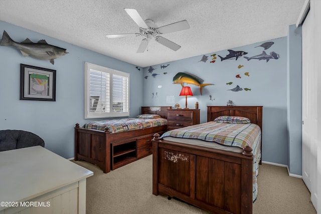 carpeted bedroom with ceiling fan and a textured ceiling