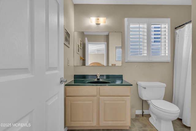 bathroom featuring vanity, tile patterned flooring, and toilet