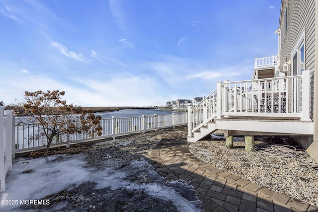 exterior space featuring a deck with water view