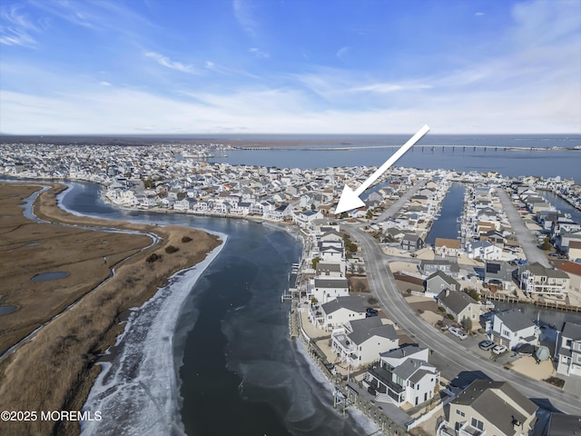 drone / aerial view with a beach view and a water view