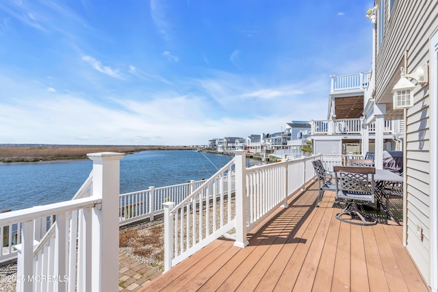 wooden deck featuring a water view