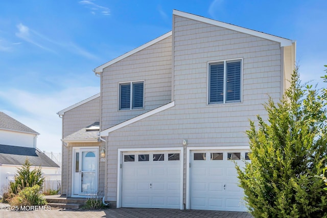 traditional-style house featuring an attached garage and driveway